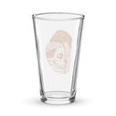 Glass pint glass featuring a split illustration of a human head showing both a brain and a skull design.