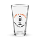 Clear pint glass featuring text 'Conan O'Brien Needs A Friend' with a microphone graphic in the center.