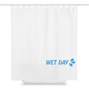 White shower curtain displayed flat, hanging from a row of evenly spaced metal hooks along a top rod. The curtain is plain and minimal with a smooth fabric surface and subtle folds. In the lower right corner, light blue text reads ‘WET DAY’ followed by three stylized water droplet shapes angled outward. The rest of the curtain is unadorned, emphasizing a clean, simple design with a small graphic accent.