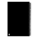 Flat view of the solid black back cover of the spiral notebook. A small QR code is visible in the bottom left corner.