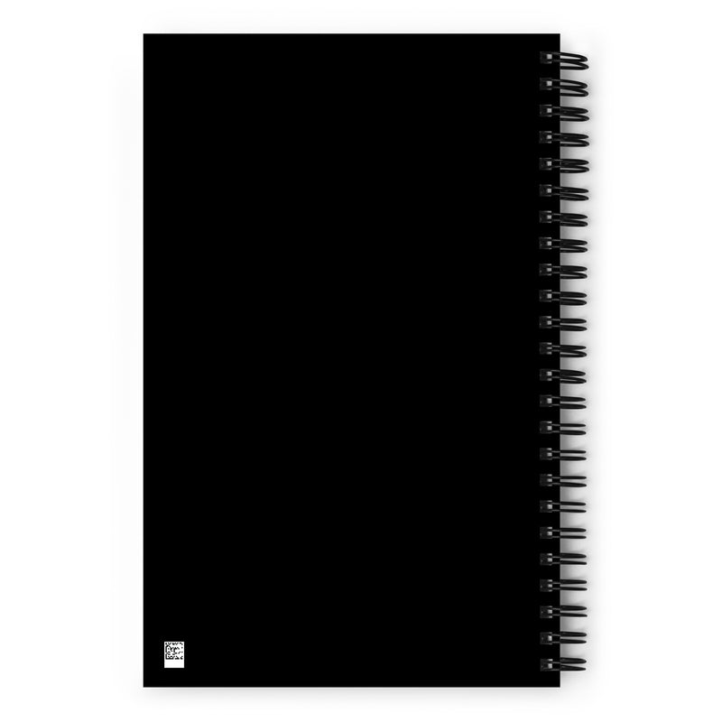 Flat view of the solid black back cover of the spiral notebook. A small QR code is visible in the bottom left corner.