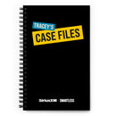 Flat view of a black spiral-bound notebook with the cover title 'TRACEY'S CASE FILES'. The title features contrasting cyan and yellow blocks with white and black text. Logos for 'SiriusXM' and 'SmartLess' are printed at the bottom.