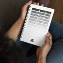 A person sits cross-legged holding a white spiral notebook in their hands. The notebook cover features the phrase 'MODERN SCRIPTURES' stacked vertically in black and gray text, fading in opacity from top to bottom. The 'VIBE CHECK' logo appears in small black capital letters near the bottom center of the cover. The person is wearing jeans and the scene is softly lit with a relaxed, indoor atmosphere.
