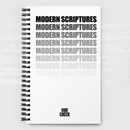 A spiral-bound notebook with a white cover featuring the phrase 'MODERN SCRIPTURES' repeated in a vertical stack. The topmost text is bold black, with each subsequent line fading in opacity to light gray. The 'VIBE CHECK' logo appears in small black capital letters near the bottom. The notebook rests against a white brick wall background with soft lighting.