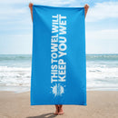 Blue towel with text stating this 'towel will keep you wet'.