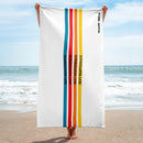 A person stands on the beach holding a vertically oriented white towel with vertical stripes in blue, red, orange, and yellow, each containing the phrase 'SEXY INDIFFERENCE' in black. The 'SiriusXM' and 'SMARTLESS' logos are printed near the top right edge.