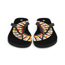 A pair of black flip-flops with a circular rainbow-striped 'BYEEEEEEE' design across both soles, interrupted by black straps. Each sandal has a white SiriusXM 'S' logo printed near the heel.