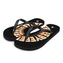 A side-angled view of a pair of black flip-flops featuring a radial 'BYEEEEEEE' pattern in bold multicolor text. The straps are textured black, and a white SiriusXM 'S' logo is visible on the heel of each footbed.