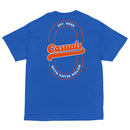 Bright royal blue short-sleeve T-shirt laid flat, showing a large back print with the word 'Casuals' in orange retro lettering across a double-line oval. Text around the oval reads 'EST. 2025' on top and 'WITH KATIE NOLAN' on the bottom.