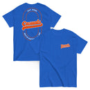 Two royal blue short-sleeve T-shirts laid flat, one showing the front and one showing the back. The front displays a small orange and white 'Casuals WITH KATIE NOLAN' logo on the left chest, and the back features a large orange 'Casuals' design with the text 'EST. 2025' and 'WITH KATIE NOLAN' arranged in a circular layout within a double-line oval.