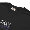 Close-up of the upper front of a black heavyweight T-shirt showing the ribbed crew neckline and smooth cotton fabric. Centered on the chest is the word ‘MORBID’ stacked three times in capital letters. The top two lines are printed in white, and the bottom line is printed in deep purple. The lettering has a slightly distressed serif style against the solid black background.