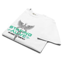 White T-shirt neatly folded to display the chest graphic, which includes a caduceus (a winged staff with two snakes), bold mint green 'STAYING ALIVE' text, and black text reading 'Jon Gabrus' and 'Adam Pally' beneath a stylized ECG line.