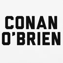Close-up of the centered chest graphic on a white T-shirt showing thick, black varsity-style block lettering that reads ‘CONAN O’BRIEN’ stacked in two lines. The crisp black letters contrast sharply against the smooth white cotton fabric, with clean edges and evenly spaced alignment clearly visible in the tight crop.