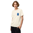 Model facing forward wearing an oversized off-white t-shirt with a small, oval-shaped blue logo on the left chest featuring palm trees and ‘Summer S’mores with Conan & the Chill Chums, Los Angeles, CA’.