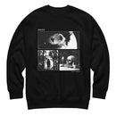 Front view of a black crewneck sweatshirt on a white background. Centered on the chest is a rectangular black-and-white collage framed with thin white lines. The top image shows an eye with silhouetted hands inside the pupil. Below it, a hooded figure stands in a forest on the left, and a skull rests on books beside a candle, dice, and a jawbone on the right. The print includes the words ‘MORBID’ at the upper left and ‘KEEP IT WEIRD’ at the lower right.