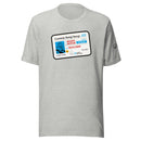 A heather gray t-shirt with a large graphic of a novelty driver's license reading 'Comedy Bang! Bang!' and featuring the name 'Motor Mouth', with a birthdate of '05/01/2009' and illustration of a wind-up chatter teeth toy. The sleeve includes black text reading 'Comedy Bang! Bang! 16 YEARS'.