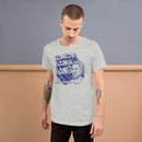 Athletic heather short-sleeve t-shirt with a large blue graphic reading 'COMEDY BING BONG WITH SCOTT AUKERMAN' and an illustrated face on the right. Worn by a man with tattoos on both arms, standing against a two-tone beige and gray wall.