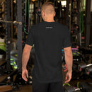 A person wearing a black heather T-shirt viewed from the back in a gym setting. Near the neckline are small white logos that read 'SiriusXM' and 'SMARTLESS'.