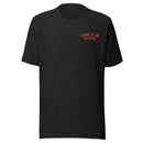 A black heather unisex t-shirt with red text printed on the left chest. The text reads 'LEAVE IT IN, SHANTEL' in an all-caps arched font. The shirt has a classic crew neckline and short sleeves.