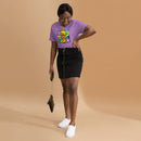A woman smiling while wearing a heather purple short-sleeve T-shirt tucked into a black skirt with a front zipper. The shirt features a colorful six-panel comic-style design with the text 'HIDDEN LEVELS,' '99% Invisible,' and 'Endless Thread' on the front.
