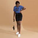 Heather true royal short-sleeve t-shirt with black text 'CALVINS TWINS' above a horse collision illustration with black stars, and smaller text 'BEE HONEY HORSE FIGHT FIELDS' and 'YA GOTTA LAUGH!' Worn by a woman indoors, paired with a black skirt and white slip-on sneakers, holding a small purse.