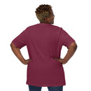 Maroon short-sleeve t-shirt shown from the back with no visible graphics, worn by a woman standing with hands on hips.