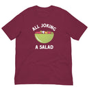 Maroon short-sleeve t-shirt with a large green salad bowl graphic on the chest filled with vegetables, surrounded by white text that reads 'ALL JOKING A SALAD'.