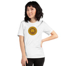 White short-sleeve t-shirt with a circular yellow and brown chest logo reading 'HEY NONG MAN' in block letters, worn by a woman standing with one hand on her hip.