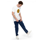 White short-sleeve t-shirt with the circular yellow and brown 'HEY NONG MAN' logo centered on the chest, worn by a man laughing while lifting one leg playfully, dressed in blue jeans and white sneakers.