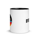 White mug with black interior with a design featuring a colorful circular graphic and black text on opposite sides.