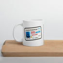 A white mug printed with the 'Comedy Bang! Bang!' license design placed on a light wooden tray, featuring the name 'Motor Mouth' and the date '05/01/2009' on the front.