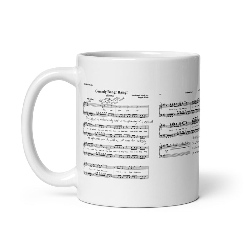 White mug displaying sheet music for the song 'Comedy Bang! Bang!' with handwritten notes and annotations.