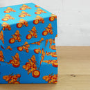 Colorful gift boxes wrapped in blue paper featuring a 'Comedy Bang! Bang!' logo.