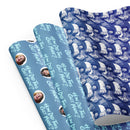 Three rolls of patterned wrapping paper featuring faces and text 'How Did This Get Made'? in various colors.