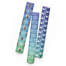 Three rolls of patterned wrapping paper featuring faces and text 'How Did This Get Made'? in various colors.