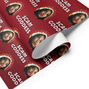 Wrapping paper featuring a woman with a halo, text reads 'SCAM GODDESS' on a red background.
