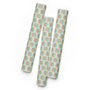 Colorful patterned wrapping paper featuring abstract shapes in pastel hues arranged in a repeating design.