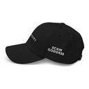 black baseball cap with the text 'SCAM GODDESS' in white embroidery.