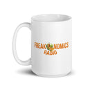 White mug with 'Freakonomics Radio Network' logo and fruit graphic.