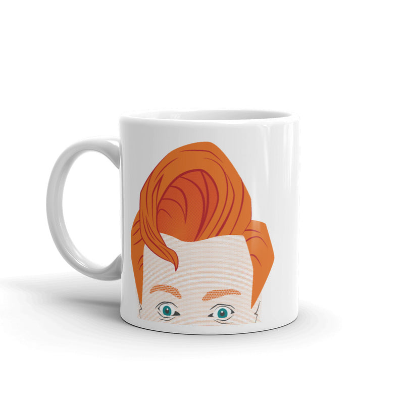 A white mug featuring an illustration of a stylized face with orange hair and blue eyes.