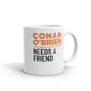 Backside of white mug with the text 'Conan O'Brien Needs A Friend' in bold orange and black letters on a white background.