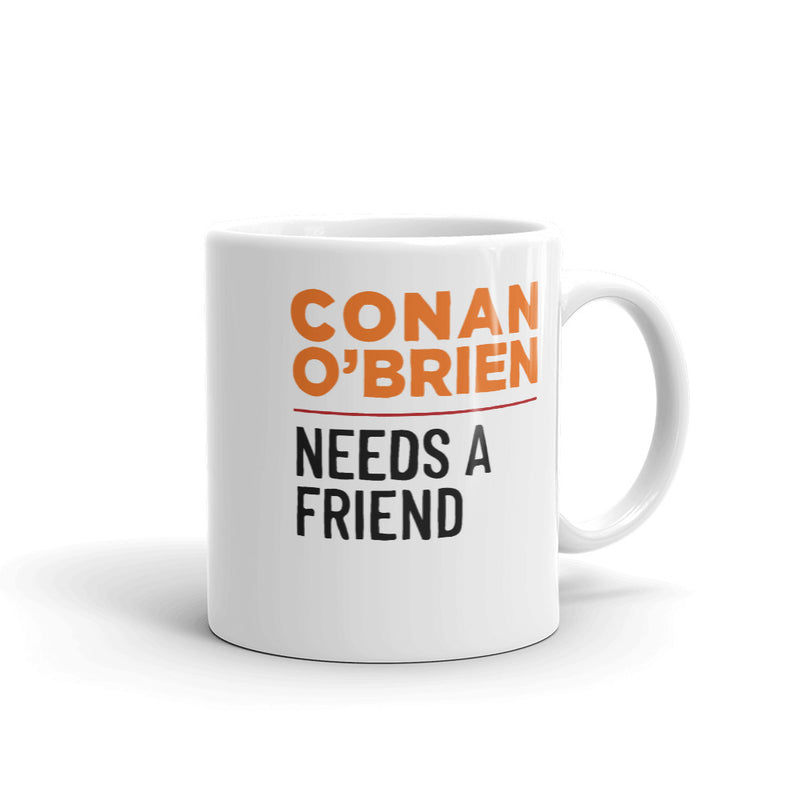 Backside of white mug with the text 'Conan O'Brien Needs A Friend' in bold orange and black letters on a white background.