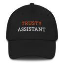 Black cap with embroidered text reading 'Trusty Assistant' in orange and white colors.