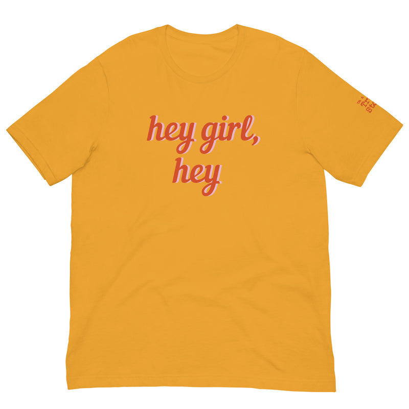 Golden yellow t-shirt with the text 'Hey Girl, Hey' in a red. stylish font.