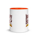 Ceramic mug with orange interior. View opposite handle.