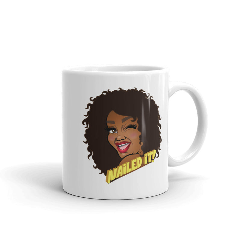 White mug featuring cartoon illustration of a smiling woman with curly hair and the text 'Nailed It!'