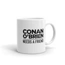 white mug with text reading 'CONAN O'BRIEN NEEDS A FRIEND.'