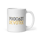 White mug with black and yellow text saying 'PODCAST DEVOTEE' in bold font.